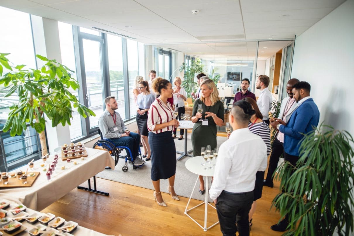 A group of individuals gathered around a table filled with delicious food and refreshing beverages